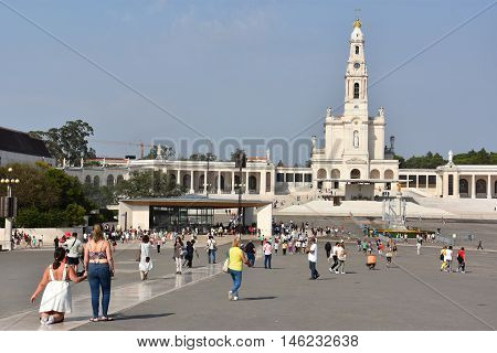 FATIMA, PORTUGAL - AUG 24: Sanctuary of Fatima in Portugal, as seen on Aug 24, 2016. It consists of a tall centralized bell-tower and nave, 213 ft in height, decorated by a 15,000 lb crown of bronze.