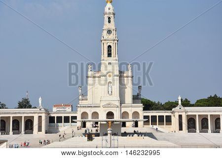 FATIMA, PORTUGAL - AUG 24: Sanctuary of Fatima in Portugal, as seen on Aug 24, 2016. It consists of a tall centralized bell-tower and nave, 213 ft in height, decorated by a 15,000 lb crown of bronze.