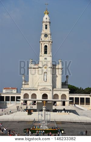 FATIMA, PORTUGAL - AUG 24: Sanctuary of Fatima in Portugal, as seen on Aug 24, 2016. It consists of a tall centralized bell-tower and nave, 213 ft in height, decorated by a 15,000 lb crown of bronze.