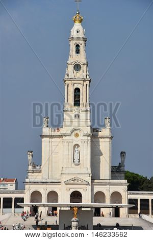 FATIMA, PORTUGAL - AUG 24: Sanctuary of Fatima in Portugal, as seen on Aug 24, 2016. It consists of a tall centralized bell-tower and nave, 213 ft in height, decorated by a 15,000 lb crown of bronze.