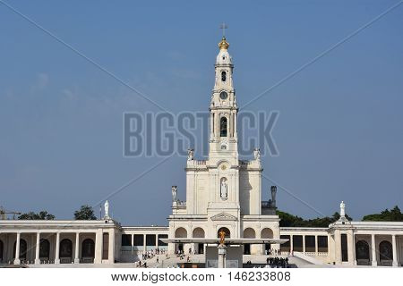 FATIMA, PORTUGAL - AUG 24: Sanctuary of Fatima in Portugal, as seen on Aug 24, 2016. It consists of a tall centralized bell-tower and nave, 213 ft in height, decorated by a 15,000 lb crown of bronze.
