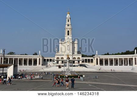 FATIMA, PORTUGAL - AUG 24: Sanctuary of Fatima in Portugal, as seen on Aug 24, 2016. It consists of a tall centralized bell-tower and nave, 213 ft in height, decorated by a 15,000 lb crown of bronze.