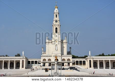 FATIMA, PORTUGAL - AUG 24: Sanctuary of Fatima in Portugal, as seen on Aug 24, 2016. It consists of a tall centralized bell-tower and nave, 213 ft in height, decorated by a 15,000 lb crown of bronze.