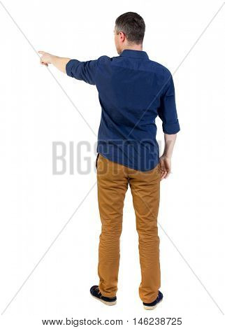 Back view of pointing business man. man in a blue shirt with the sleeves rolled up showing the right hand side.