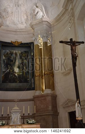 FATIMA, PORTUGAL - AUG 24: Sanctuary of Fatima in Portugal, as seen on Aug 24, 2016. It consists of a tall centralized bell-tower and nave, 213 ft in height, decorated by a 15,000 lb crown of bronze.