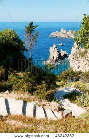 Small beautiful lagoon on Corfu island Greece. Steps on foreground. Vertial shot