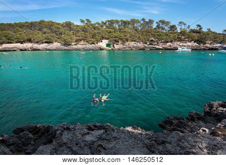 Couple Snorkeling In Clear Turquoise Water