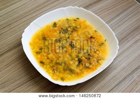 A plate of pea soup is on the table