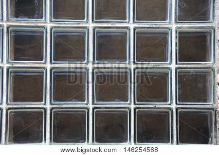 Background image shows large window composed of individual squares of thick glass. Building is in Stoughton Wisconsin.