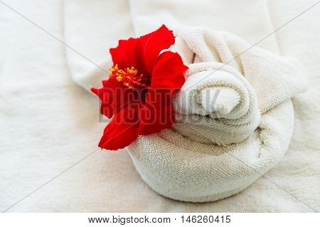 white towel with a flower on white background