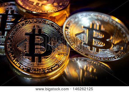 Photo Golden Bitcoins new virtual money Close-up on a black background.