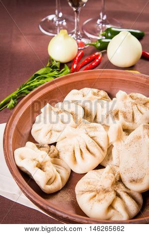 hot fresh georgian food.hinkali with parsley in restaurant