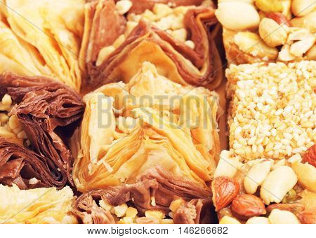 different oriental sweets baklava on wooden table