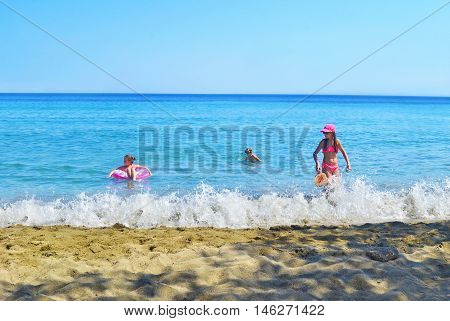 SIFNOS GREECE, AUGUST 27 2016: kids playing at the sea Sifnos island Cyclades Greece. Editorial use.
