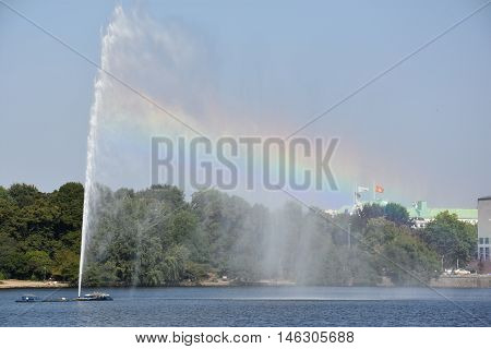 HAMBURG, GERMANY - AUG 26: Fountain at Alster Lake in Hamburg, Germany, as seen on Aug 26, 2016. In the city center, the Alster river forms two lakes, both prominent features in Hamburg's cityscape.