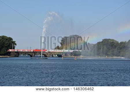 HAMBURG, GERMANY - AUG 26: Fountain at Alster Lake in Hamburg, Germany, as seen on Aug 26, 2016. In the city center, the Alster river forms two lakes, both prominent features in Hamburg's cityscape.