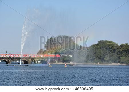 HAMBURG, GERMANY - AUG 26: Fountain at Alster Lake in Hamburg, Germany, as seen on Aug 26, 2016. In the city center, the Alster river forms two lakes, both prominent features in Hamburg's cityscape.