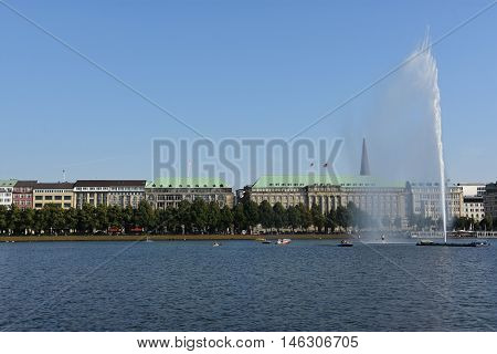 HAMBURG, GERMANY - AUG 26: Fountain at Alster Lake in Hamburg, Germany, as seen on Aug 26, 2016. In the city center, the Alster river forms two lakes, both prominent features in Hamburg's cityscape.