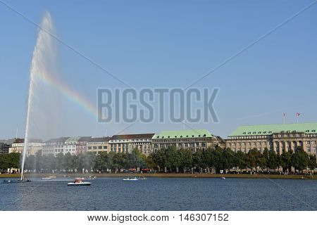 HAMBURG, GERMANY - AUG 26: Fountain at Alster Lake in Hamburg, Germany, as seen on Aug 26, 2016. In the city center, the Alster river forms two lakes, both prominent features in Hamburg's cityscape.