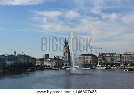 HAMBURG, GERMANY - AUG 26: Fountain at Alster Lake in Hamburg, Germany, as seen on Aug 26, 2016. In the city center, the Alster river forms two lakes, both prominent features in Hamburg's cityscape.