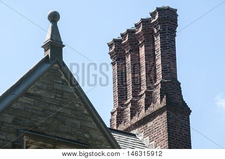 Old vintage brick chimneys on roof of old building