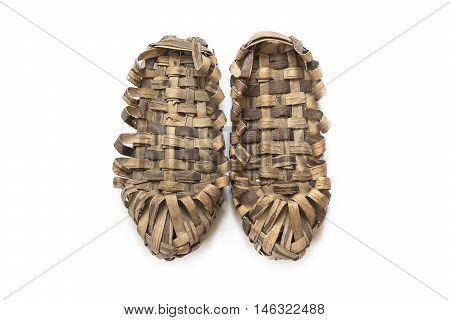 Pair of bast shoes on a wooden background