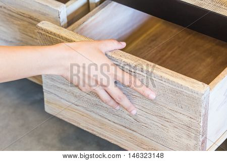 Use right hand pull open drawer wooden in cabinet.