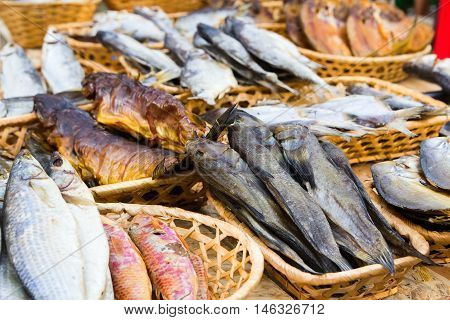 Different kinds of dried fish in the store in baskets at beer fesival