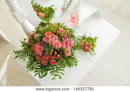 Pink bouquet of flowers on a white table