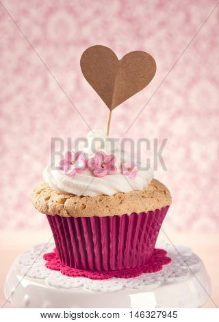 Cupcake with a heart cakepick
