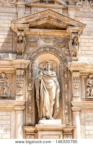 Statue on Giureconsulti palace in the center of Milan