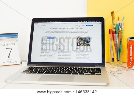 PARIS FRANCE - SEP 8 2016: Apple Computers website on MacBook Pro Retina in a geek creative room environment showcasing QuickType Maps and Photos