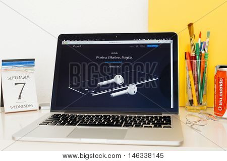 PARIS FRANCE - SEP 8 2016: Apple Computers website on MacBook Pro Retina in a geek creative room environment showcasing iPhone 7 and AirPods