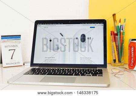 PARIS FRANCE - SEP 8 2016: Apple Computers website on MacBook Pro Retina in a geek creative room environment showcasing AirPods secs