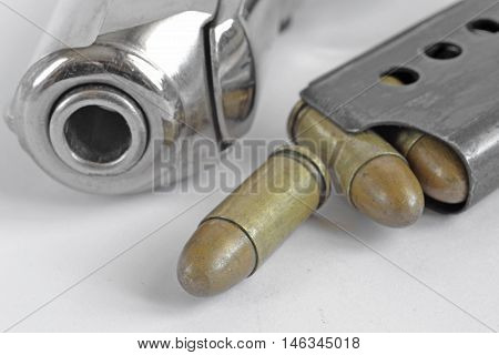 Pistol and ammunition on the white background.