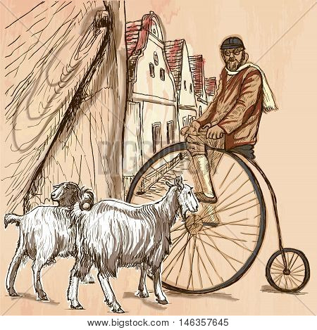 BICYCLIST.Cyclist on the velocipede posing at the old village. In front of old houses are also two goats.Freehand sketching line drawing. An hand drawn vector illustration.Colored line art technique.
