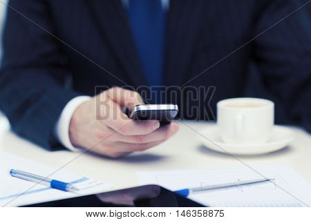 business, technology and interent concept - businessman with smartphone reading news