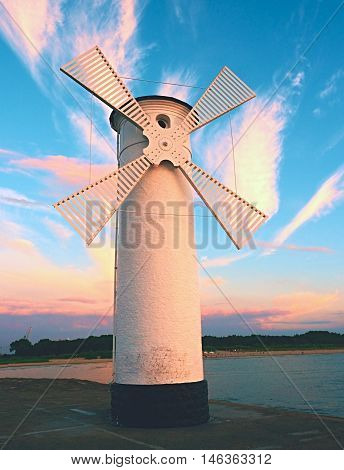 White Windmill By Sea On Rocky Coast. Seascape And Landscape