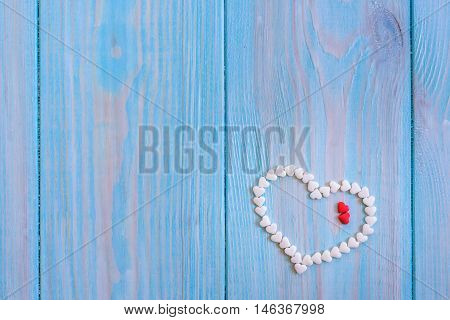 Red Candy Heart Laying On White Painted Rustic Wooden Background