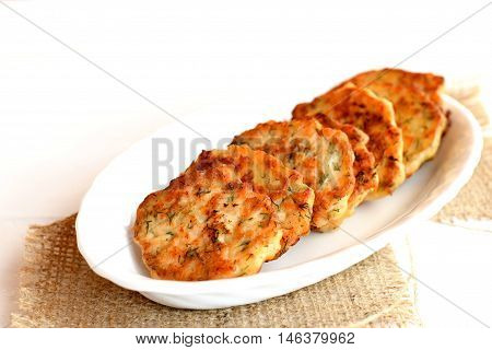 Fried fish cutlets with dill on a plate. Cutlets made from minced salmon meat and dill. Tasty salmon recipe
