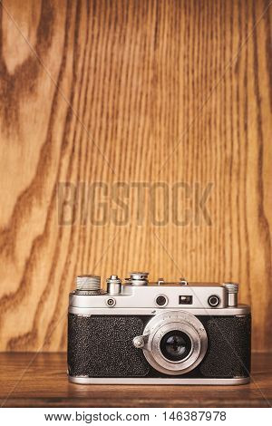 Vintage camera on wooden background. Close up.