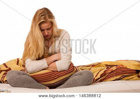 Woman Sitting On Bed Holding Belly Because Of The Pain In Stomac.
