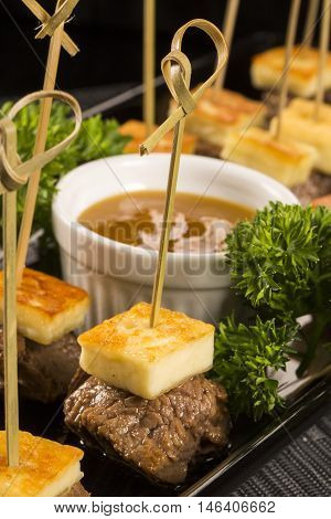 Gourmet skewer portion of meat with cheese curds