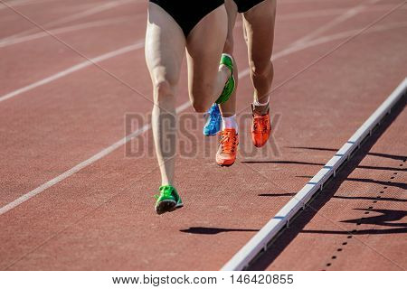 girls runners run on track stadium. competitions in athletics. leader of race