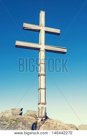 Big cross on the hill Dumbier in Low Tatras mountains. Travelling theme. Retro photo filter. Beautiful place. Symbolic object. Vertical composition.