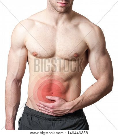 Muscular shirtless young man with stomach pain