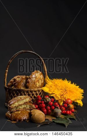 Typical Dutch filled spicy cookies with almonds on autumn colored and dark background