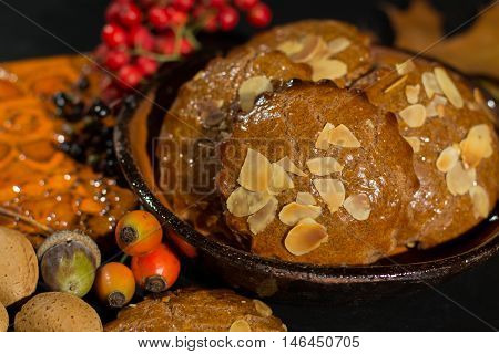 Typical Dutch filled spicy cookies with almonds on autumn colored and dark background