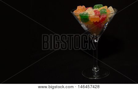 Tasty glass of sweet gummy bears in a cocktail glass. A holiday favorite for the kiddos that dress up the table.