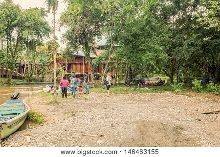 Lago Agrio Ecuador - 19 March 2015 Tourists Loading Supplies On Wooden Boats Ready To Take Passengers To Cuyabeno Wildlife Reserve South America
